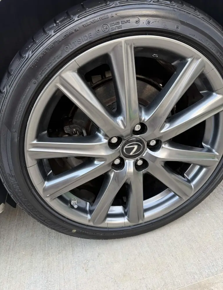 The same Lexus alloy wheel polished to a mirror finish with the tire dressed black