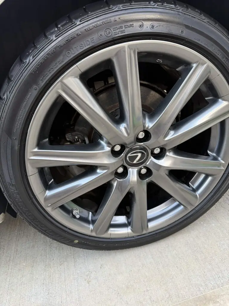 The same Lexus alloy wheel polished to a mirror finish with the tire dressed black